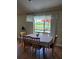 Dining area with table and chairs, large window, and view of the pool outside at 2357 Great Harbor Dr, Kissimmee, FL 34746