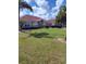 Inviting home exterior boasting a verdant lawn, manicured bushes, and convenient driveway parking at 2357 Great Harbor Dr, Kissimmee, FL 34746