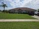 Well-maintained single-story home featuring a lush green lawn and mature landscaping at 2357 Great Harbor Dr, Kissimmee, FL 34746