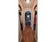 Hallway featuring decorative archways leading to closet and bedroom areas, with tile floors for easy maintenance at 2357 Great Harbor Dr, Kissimmee, FL 34746