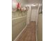 Narrow hallway with wood-look tile floors and hat storage at 2357 Great Harbor Dr, Kissimmee, FL 34746