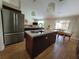 Kitchen and dining area featuring stainless steel appliances, island seating, and tile flooring at 2357 Great Harbor Dr, Kissimmee, FL 34746