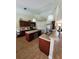 Open kitchen with bar seating, stainless appliances, tile backsplash, and modern pendant lighting at 2357 Great Harbor Dr, Kissimmee, FL 34746