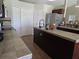 A large kitchen island with sink, stainless appliances, and decorative tile back splash at 2357 Great Harbor Dr, Kissimmee, FL 34746