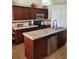 Modern kitchen with dark wood cabinets, granite countertops, stainless steel appliances, and a center island at 2357 Great Harbor Dr, Kissimmee, FL 34746
