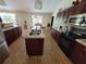 Spacious kitchen with stainless steel appliances, island with double sink, and dark wood cabinetry at 2357 Great Harbor Dr, Kissimmee, FL 34746