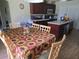 Eat-in kitchen featuring cherry cabinets, tile countertops and backsplash, and stainless appliances at 2357 Great Harbor Dr, Kissimmee, FL 34746