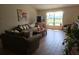 Comfortable living room featuring wood floors, ample sunlight, and stylish decor at 2357 Great Harbor Dr, Kissimmee, FL 34746