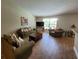 Living room with wood tile flooring, neutral paint and furniture arrangement with TV at 2357 Great Harbor Dr, Kissimmee, FL 34746