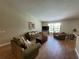 Spacious living room featuring tile floors, two sofas, comfortable seating, and lots of natural light at 2357 Great Harbor Dr, Kissimmee, FL 34746