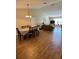 Living room with wood tile floors, neutral paint, TV and easy access to the dining room at 2357 Great Harbor Dr, Kissimmee, FL 34746