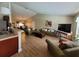 Open-concept living room with wood tile floors, a sofa, and ample space for entertaining at 2357 Great Harbor Dr, Kissimmee, FL 34746
