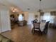 Open-concept living space featuring wood-look tile floors, neutral colors, and an inviting atmosphere at 2357 Great Harbor Dr, Kissimmee, FL 34746