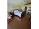 Vaulted ceiling main bedroom featuring wood floors, ceiling fan, dresser and hallway entry at 2357 Great Harbor Dr, Kissimmee, FL 34746