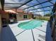 This backyard oasis features a screened-in pool, lounge area, and lovely landscaping at 2357 Great Harbor Dr, Kissimmee, FL 34746