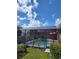 Screened in pool area with lush landscaping, providing a private and relaxing oasis at 2357 Great Harbor Dr, Kissimmee, FL 34746