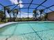 Enjoy a refreshing swim in this screened-in pool surrounded by lush landscaping at 2357 Great Harbor Dr, Kissimmee, FL 34746