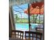 Backyard view from inside the house features a pool, patio, and privacy fence at 2357 Great Harbor Dr, Kissimmee, FL 34746