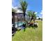 Backyard oasis featuring a screened-in pool, meticulously maintained landscaping, and outdoor relaxation spaces at 2357 Great Harbor Dr, Kissimmee, FL 34746