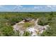 Secluded red home on expansive lot surrounded by lush greenery and mature trees creating a private oasis at 2576 R E Byrd Rd, Frostproof, FL 33843