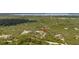 Overhead view shows a property surrounded by lush forest, providing a private and serene setting with lots of trees at 2576 R E Byrd Rd, Frostproof, FL 33843