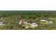 Aerial view of the property with lush trees and a vibrant green landscape at 2576 R E Byrd Rd, Frostproof, FL 33843