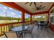 Enjoy outdoor living on this back porch with seating and views of the backyard at 2576 R E Byrd Rd, Frostproof, FL 33843