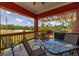 Relax on the spacious back porch, complete with outdoor furniture and a built-in grill at 2576 R E Byrd Rd, Frostproof, FL 33843