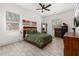 Bright bedroom features a ceiling fan, unique hardwood bed frame, and lots of natural light at 2576 R E Byrd Rd, Frostproof, FL 33843