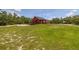 Single-story home with solar panels and a large grassy yard at 2576 R E Byrd Rd, Frostproof, FL 33843