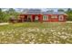 Charming single-story home featuring a solar panel system and a spacious front yard at 2576 R E Byrd Rd, Frostproof, FL 33843