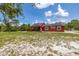 A single-story home with solar panels, a deck, and a large grassy yard at 2576 R E Byrd Rd, Frostproof, FL 33843