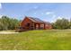 A beautiful single-story home with a wooden deck and solar panels on the roof at 2576 R E Byrd Rd, Frostproof, FL 33843