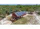 An aerial view of the house with solar panels and a spacious porch at 2576 R E Byrd Rd, Frostproof, FL 33843