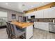 Modern kitchen featuring stainless steel appliances, a wood-top island, and white cabinetry at 2576 R E Byrd Rd, Frostproof, FL 33843