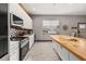 Spacious kitchen with stainless steel appliances, white cabinets and a large wood-top island at 2576 R E Byrd Rd, Frostproof, FL 33843