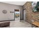 Inviting living room with decorative stone wall and a door leading to an outdoor patio with table and chairs at 2576 R E Byrd Rd, Frostproof, FL 33843