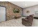 Stylish living room featuring wood-look floors, a stone accent wall and a comfortable reclining sofa at 2576 R E Byrd Rd, Frostproof, FL 33843