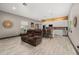 Open concept living room and kitchen with wood-look tile flooring and comfortable seating at 2576 R E Byrd Rd, Frostproof, FL 33843