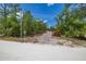 A gated entrance to the property is surrounded by lush trees, offering privacy at 2576 R E Byrd Rd, Frostproof, FL 33843