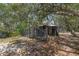 A wood and chainlink shed with surrounding trees at 2576 R E Byrd Rd, Frostproof, FL 33843