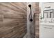 This renovated shower features decorative pebble flooring and modern fixtures at 2576 R E Byrd Rd, Frostproof, FL 33843