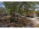 Outdoor area with storage sheds and lots of trees at 2576 R E Byrd Rd, Frostproof, FL 33843