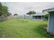 Spacious backyard featuring a play set, a screen porch, and a wooden fence at 2773 Woodstream Cir, Kissimmee, FL 34743