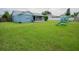 The spacious backyard features a lush lawn, an enclosed patio, and a slide and swing set at 2773 Woodstream Cir, Kissimmee, FL 34743