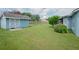 Large backyard featuring lush green grass, a storage shed, and a swing set at 2773 Woodstream Cir, Kissimmee, FL 34743