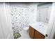 Bright bathroom featuring a shower/tub combo and a dinosaur-themed shower curtain at 2773 Woodstream Cir, Kissimmee, FL 34743
