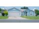 Charming one-story home featuring a well-maintained lawn and an attached two-car garage at 2773 Woodstream Cir, Kissimmee, FL 34743