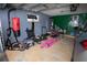 Organized garage featuring exercise equipment and ample space for storage at 2773 Woodstream Cir, Kissimmee, FL 34743