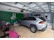 Spacious garage featuring parking, ample storage, and exercise equipment at 2773 Woodstream Cir, Kissimmee, FL 34743